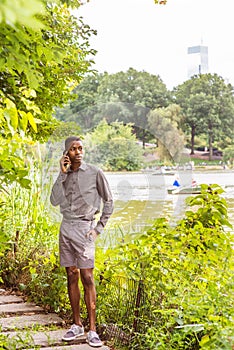 Young African American Man waiting for you at Central Park in New York