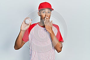 Young african american man wearing baseball uniform looking to side, relax profile pose with natural face with confident smile