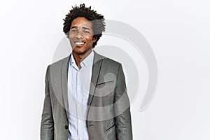 Young african american man wearing business jacket over isolated white background looking positive and happy standing and smiling