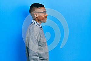 Young african american man wearing business style and glasses looking to side, relax profile pose with natural face with confident