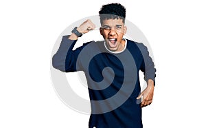 Young african american man wearing casual clothes angry and mad raising fist frustrated and furious while shouting with anger