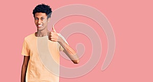 Young african american man wearing casual clothes doing happy thumbs up gesture with hand