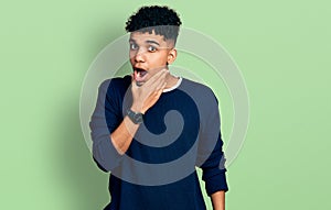 Young african american man wearing casual clothes looking fascinated with disbelief, surprise and amazed expression with hands on