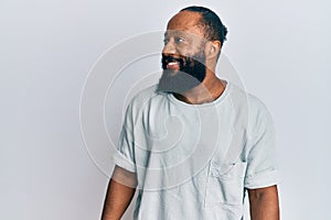 Young african american man wearing casual clothes looking to side, relax profile pose with natural face and confident smile