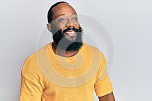 Young african american man wearing casual clothes looking to side, relax profile pose with natural face and confident smile