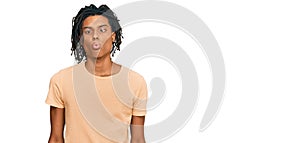 Young african american man wearing casual clothes making fish face with lips, crazy and comical gesture