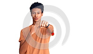 Young african american man wearing casual clothes punching fist to fight, aggressive and angry attack, threat and violence