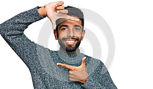 Young african american man wearing casual clothes smiling making frame with hands and fingers with happy face