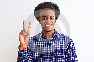Young african american man wearing casual shirt standing over isolated white background smiling with happy face winking at the