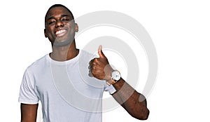 Young african american man wearing casual white t shirt doing happy thumbs up gesture with hand