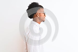 Young african american man wearing elegant shirt and glasses over isolated white background looking to side, relax profile pose