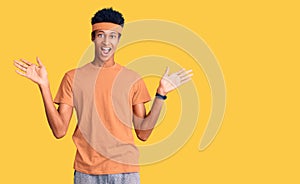 Young african american man wearing sportswear celebrating victory with happy smile and winner expression with raised hands