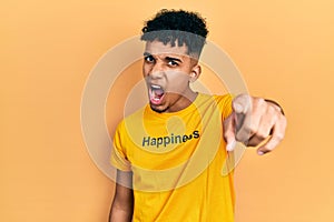 Young african american man wearing t shirt with happiness word message pointing displeased and frustrated to the camera, angry and