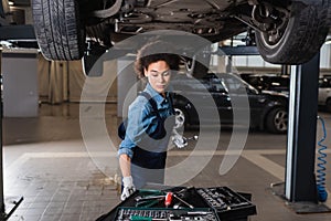 young african american mechanic in overalls