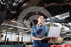 young african american mechanic standing underneath