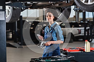 young african american mechanic standing underneath