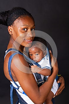 young african american mother carrying her baby in a sling