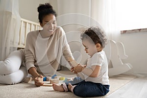 Young african American mother play with little baby