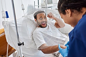 young african american nurse inserting catheter