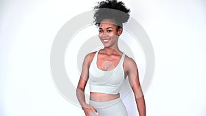 Young African American personal trainer explaining aerobics workout isolated gray background