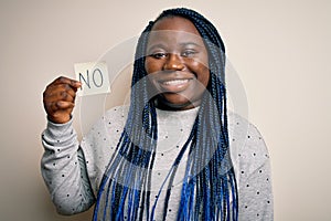 Young african american plus size woman with braids holding reminder paper with no message with a happy face standing and smiling