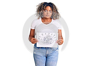 Young african american plus size woman holding scribble draw thinking attitude and sober expression looking self confident