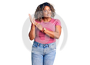 Young african american plus size woman wearing casual clothes clapping and applauding happy and joyful, smiling proud hands