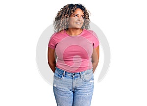 Young african american plus size woman wearing casual clothes smiling looking to the side and staring away thinking