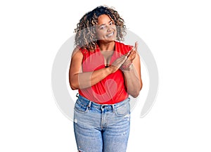 Young african american plus size woman wearing casual style with sleeveless shirt clapping and applauding happy and joyful,