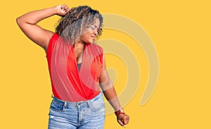Young african american plus size woman wearing casual style with sleeveless shirt stretching back, tired and relaxed, sleepy and