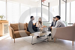 Young African American professional woman talking to diverse team