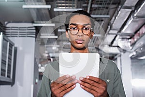 young african american programmer holding digital