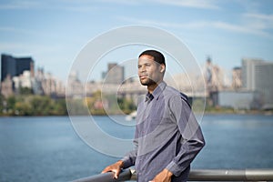 Young African American with the river and bridge in the background