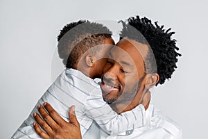 Young African American Son Hugs His Father