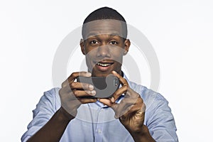 Young African American taking a picture with smartphone, horizontal