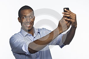 Young African American taking a selfie picture with smartphone, horizontal