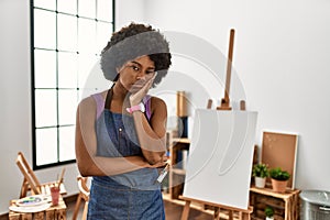 Young african american woman with afro hair at art studio thinking looking tired and bored with depression problems with crossed