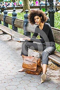 Young African American Woman with afro hairstyle traveling, working in New York City