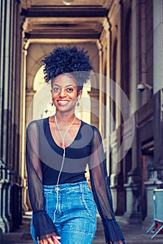 Young African American woman with afro hairstyle traveling in New York City