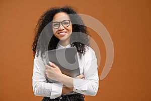 Young African American woman with afro hairstyle wearing smart casual wear and stylish eyeglasses standing isolated on