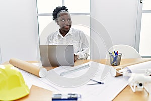 Young african american woman architect using laptop working at architecture studio