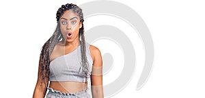 Young african american woman with braids wearing sportswear afraid and shocked with surprise expression, fear and excited face