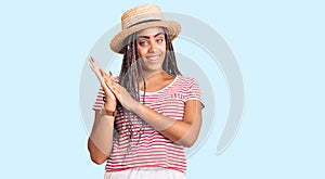 Young african american woman with braids wearing summer hat clapping and applauding happy and joyful, smiling proud hands together