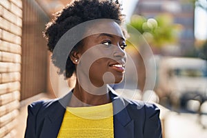 Young african american woman business executive smiling confident at street