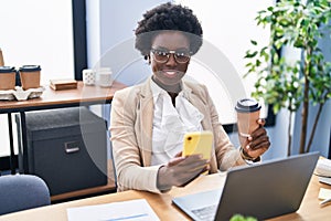 Young african american woman business worker using smartphone drinking coffee at office