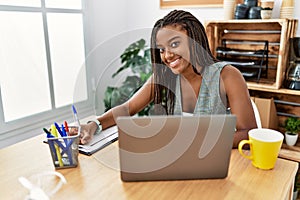 Young african american woman business worker writing on clipboard working at office