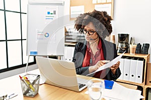 Young african american woman call center agent having video call at office