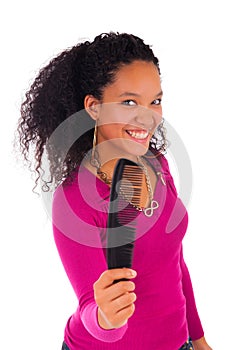 Young african american woman combing hair