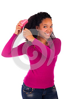 Young african american woman combing hair