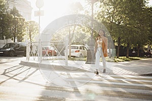 Young african american woman crossing the street